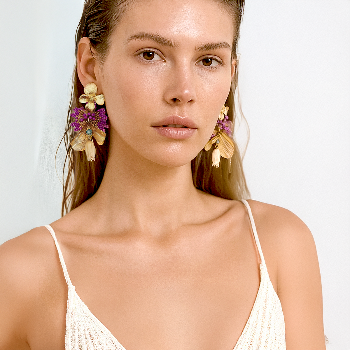 Earrings in gold leaf, woven beads, steel, opal, and preserved flower | Nuna Qori